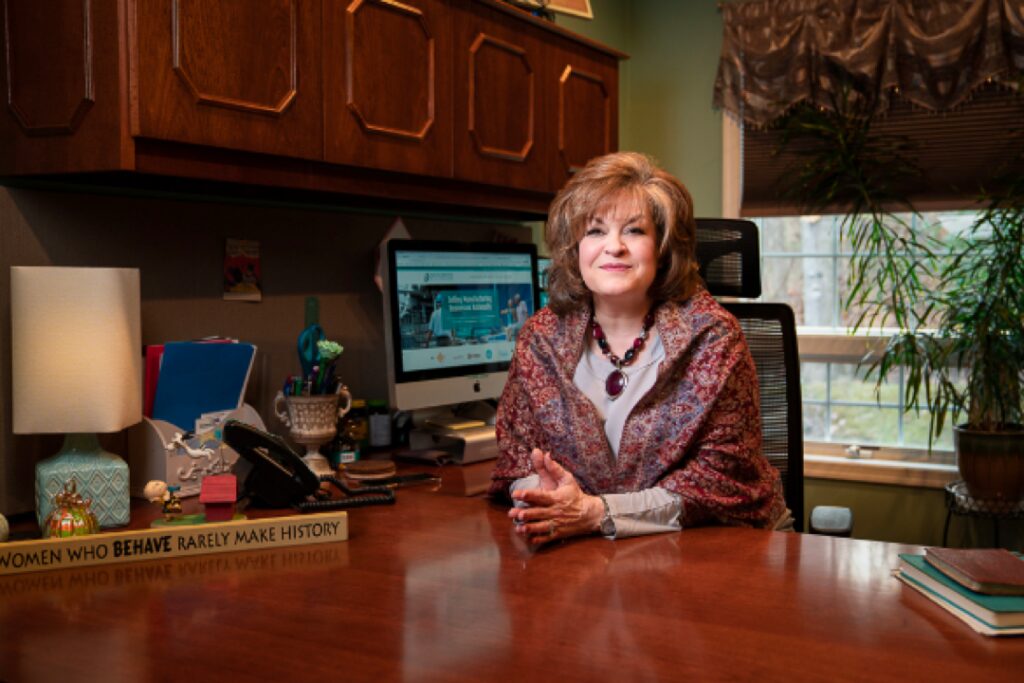 confident female business broker at desk